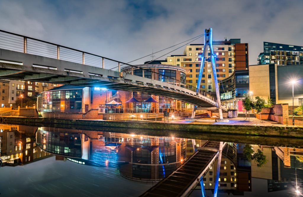 Leeds city skyline at night with illuminated bridge reflected in the River Aire - lie detector test Leeds